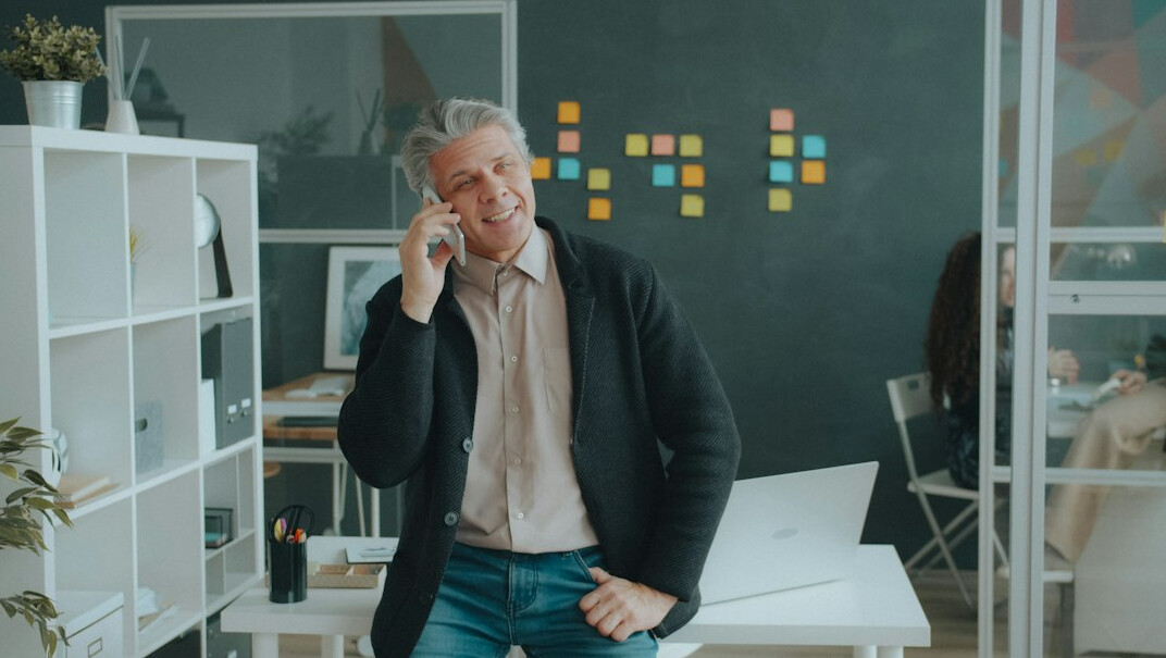 Two people having a friendly conversation in a bright office