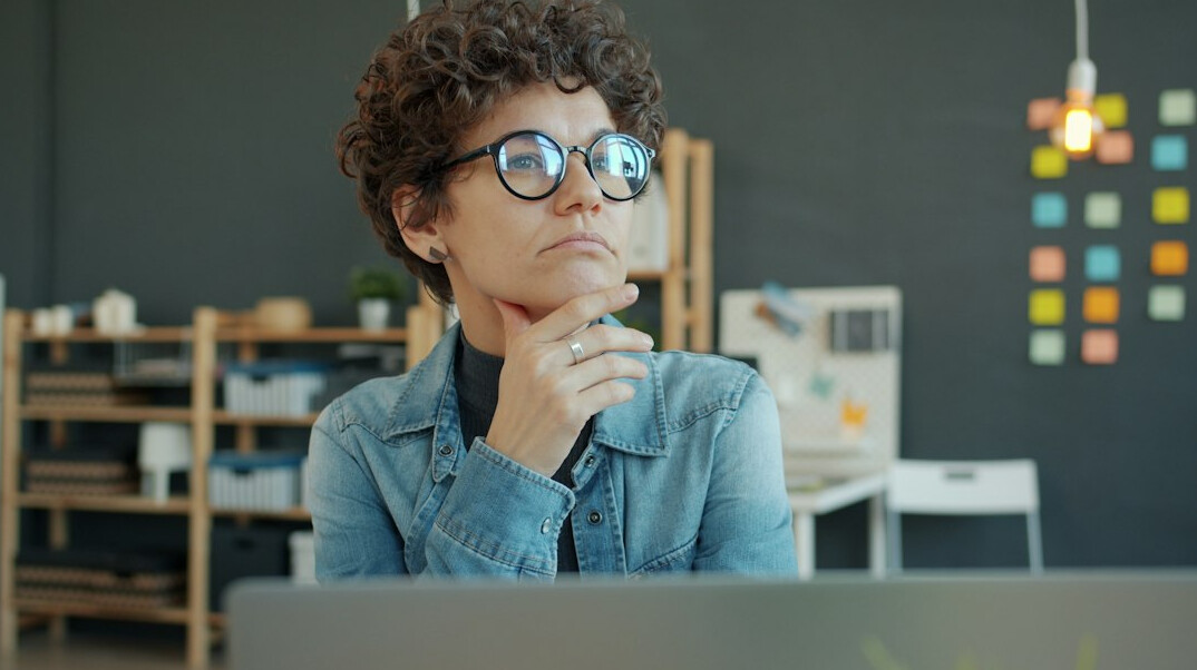 person reflecting at desk